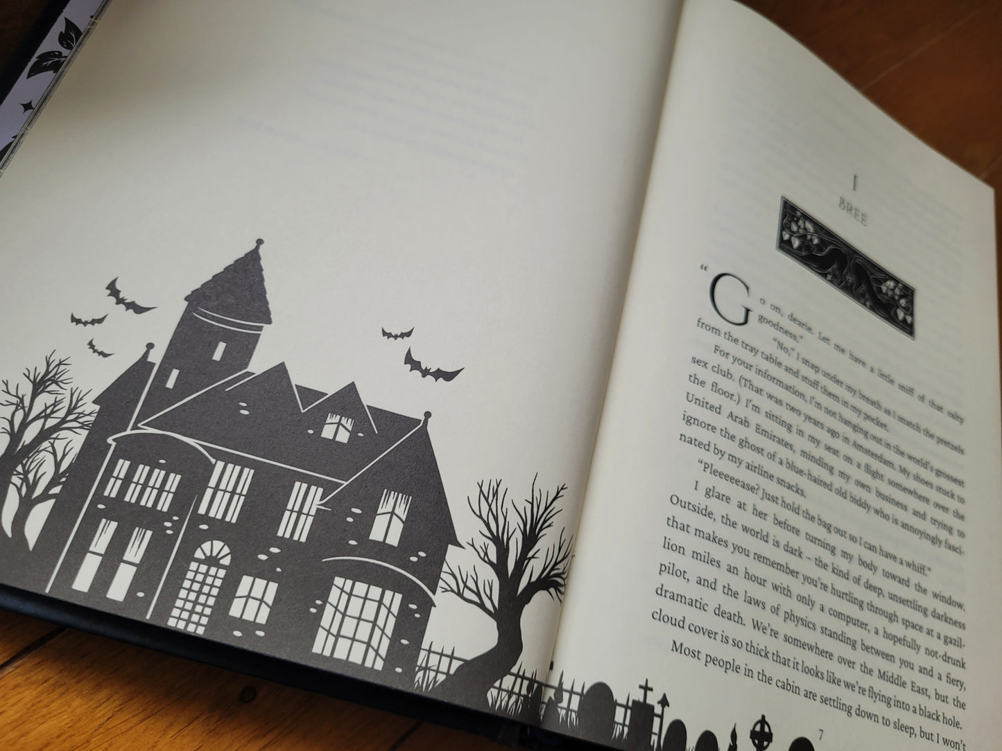 Open book showing chaper header illustrations of the Grimdale Graveyard series hardcover books