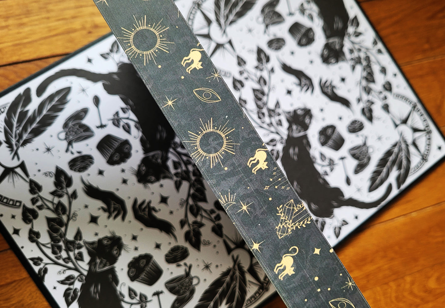 Open book showing endpaper illustrations and printed edges of the Grimdale Graveyard series hardcover books