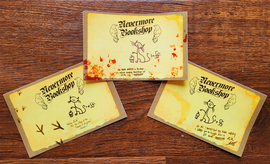 Three illustrated bookplate stickers on a wood background
